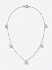A delicate white gold  chain necklace featuring five small, round-cut clear gemstones spaced evenly along the chain.The necklace is displayed on a clean white background 